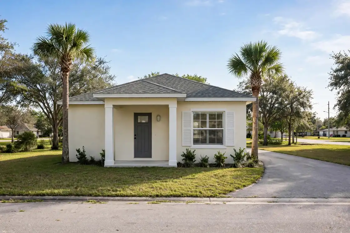 Illustration of a single-story Florida home with a gray front door, a covered porch and two palm trees