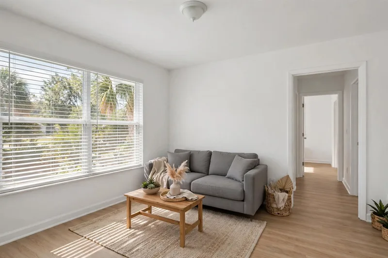 Illustration of a bright, tidy living room with a hallway door